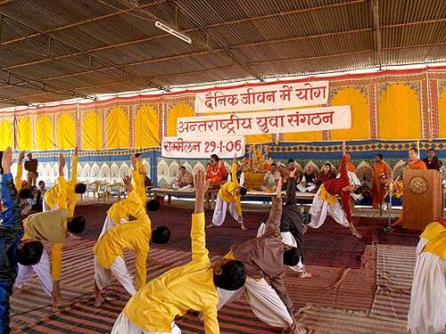 School children of Om Vishwa Deep Gurukul Swami Maheshwarananda Ashram perform yoga asanas